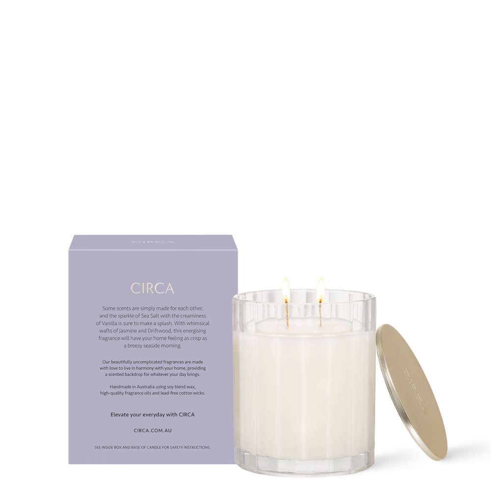 CIRCA Sea Salt and Vanilla 350g Soy Candle burning beside box - back of product shot