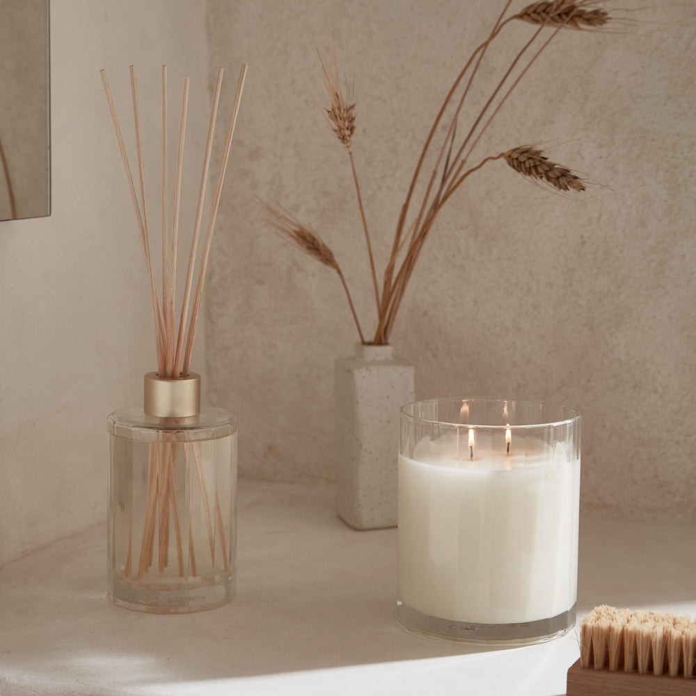 CIRCA Sea Salt and Vanilla 350g Soy Candle burning beside box - back of product shot