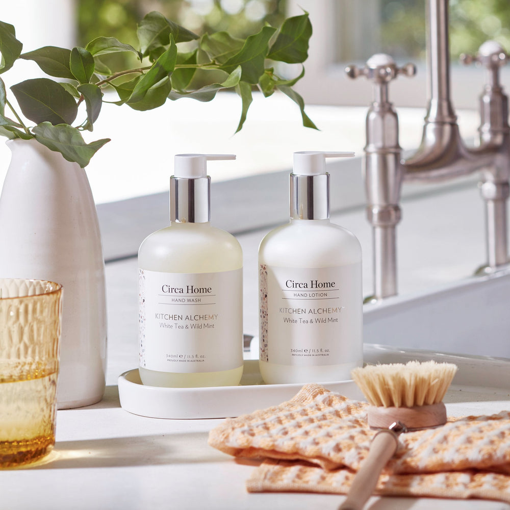 CIRCA White Tea and Wild Mint 340mL Hand Duo Set (wash and lotion on tray) sitting beside a kitchen sink